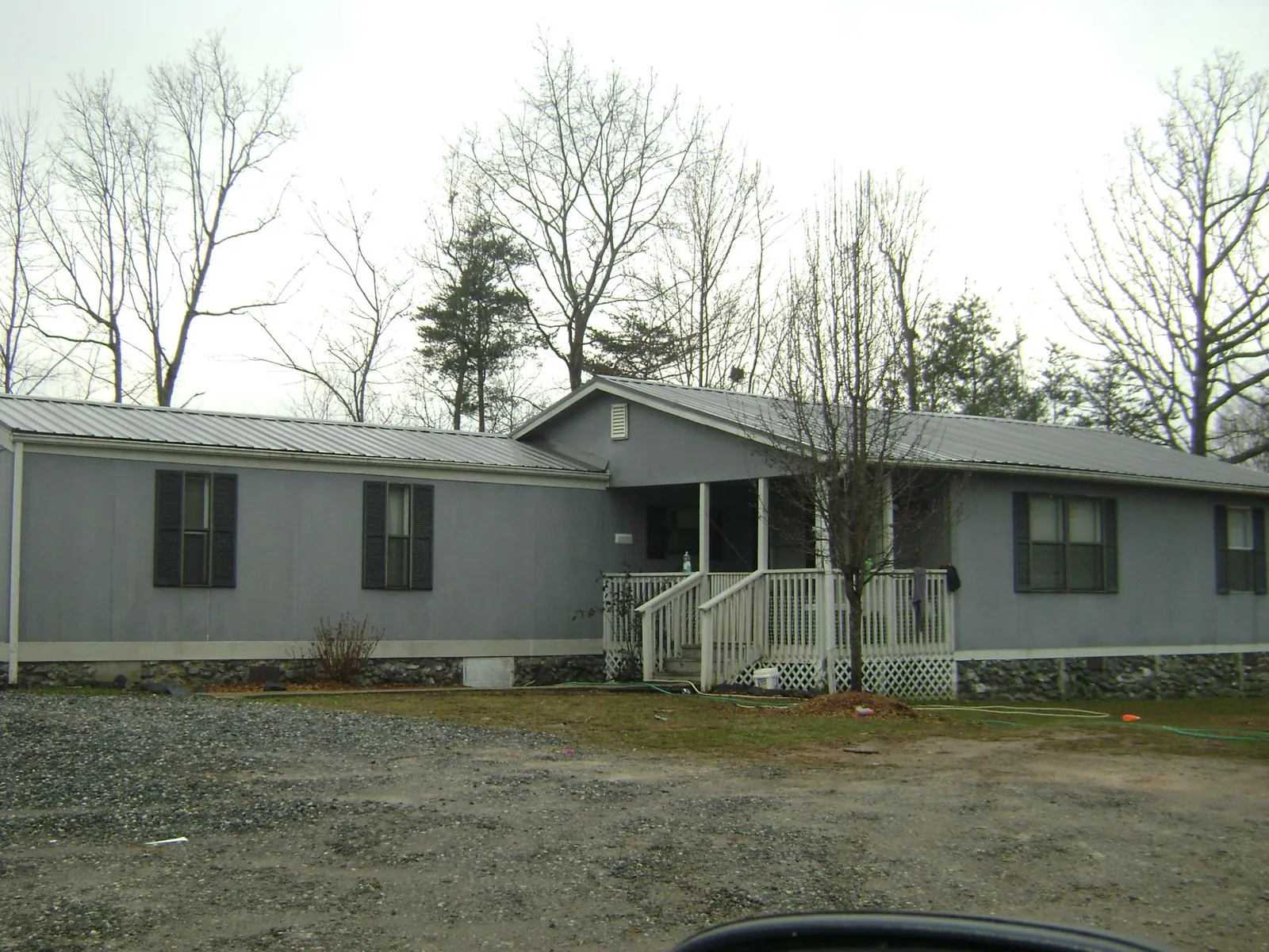 Metal roof over a manufactured home with a covered front porch in Chester